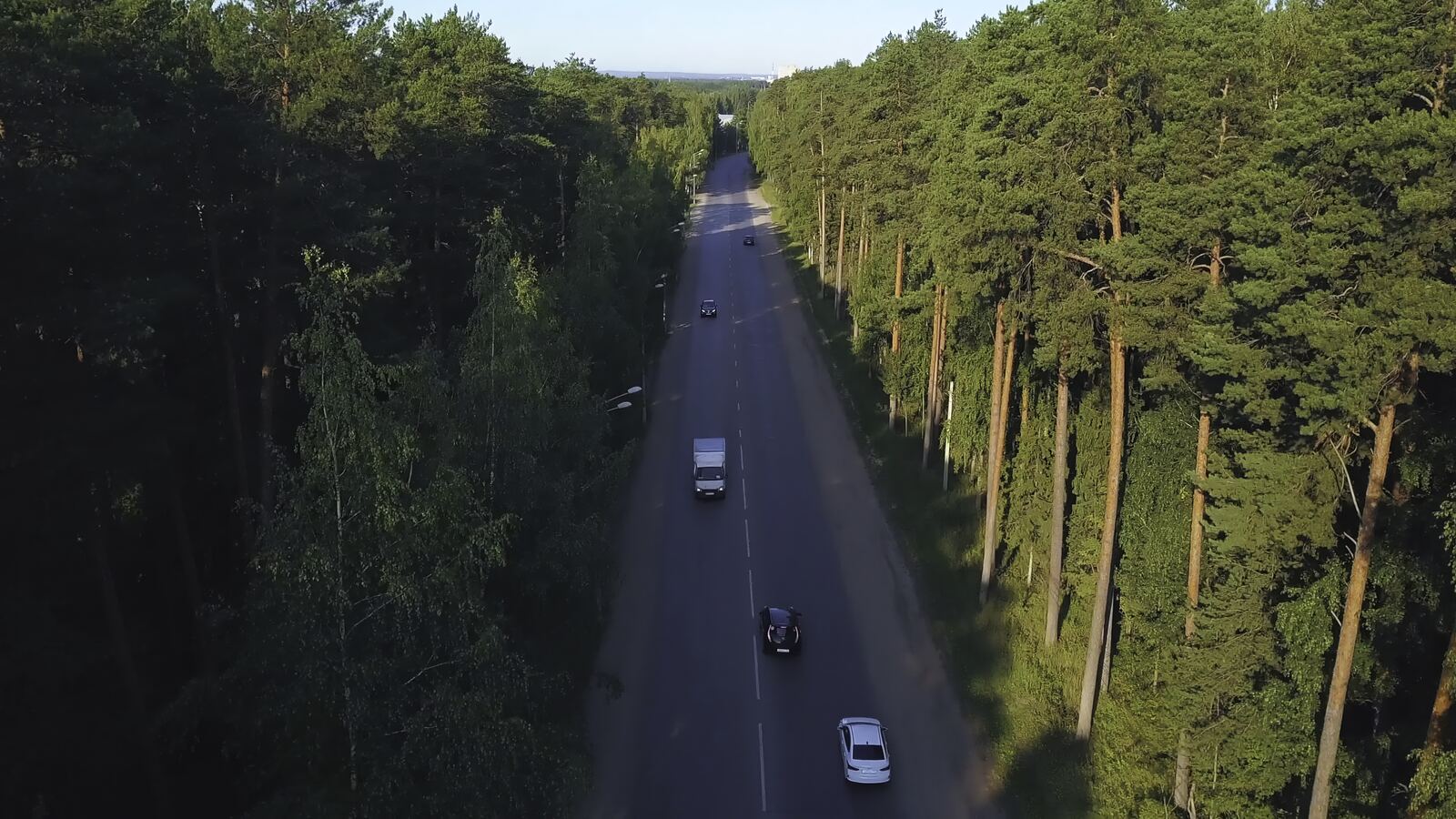 Aerial view of traffic on a tree-lined dual carriageway