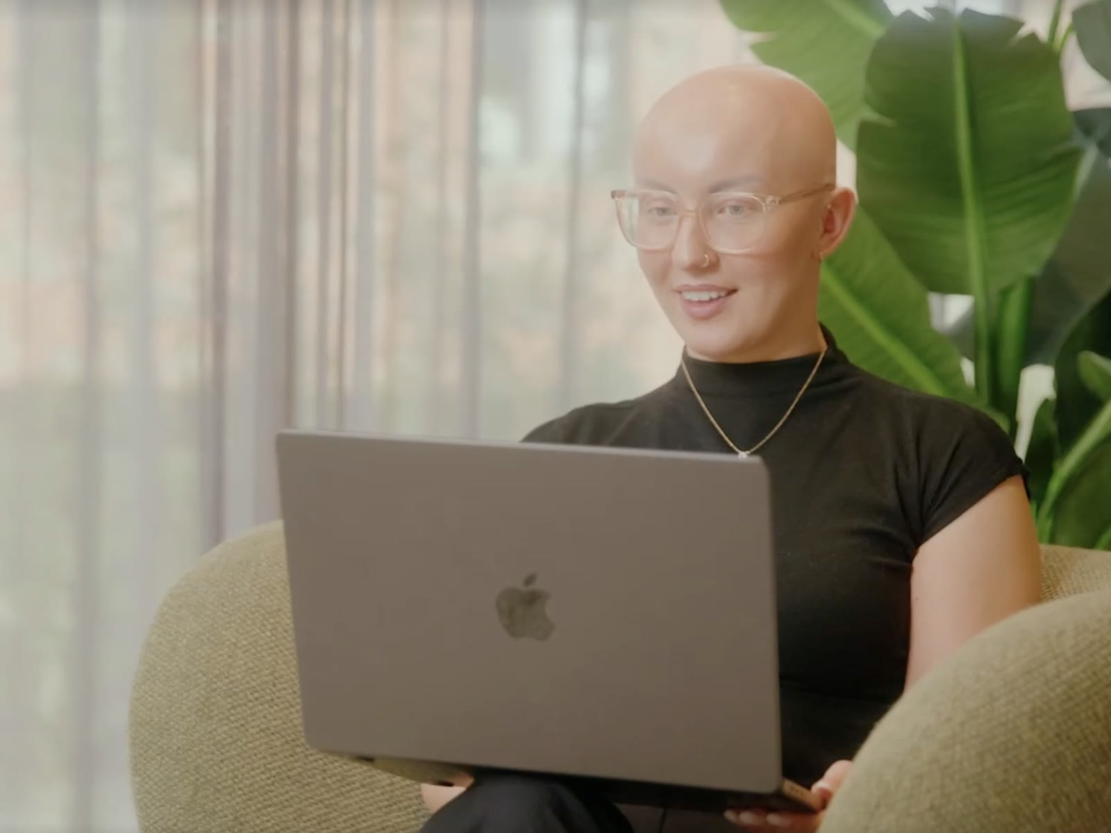 Storyhaus producer working on a laptop in an armchair